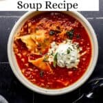 Overhead view of bowl of lasagna soup on black tile surface pin with text overlay.
