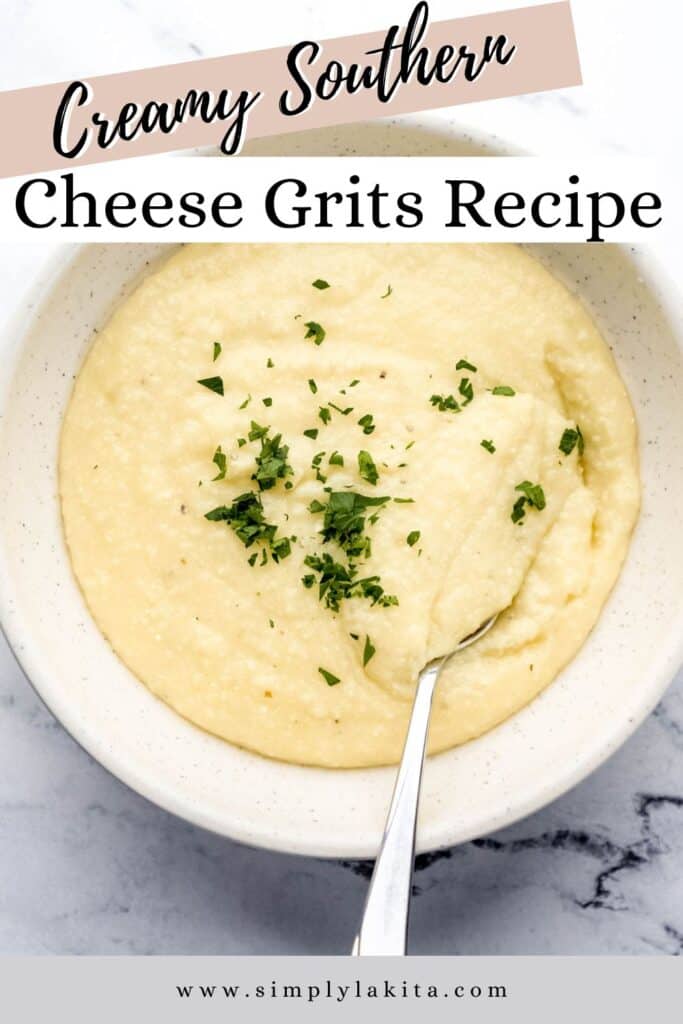 Overhead view of bowl of cheese grits with spoon in it on marble surface pin with text overlay.