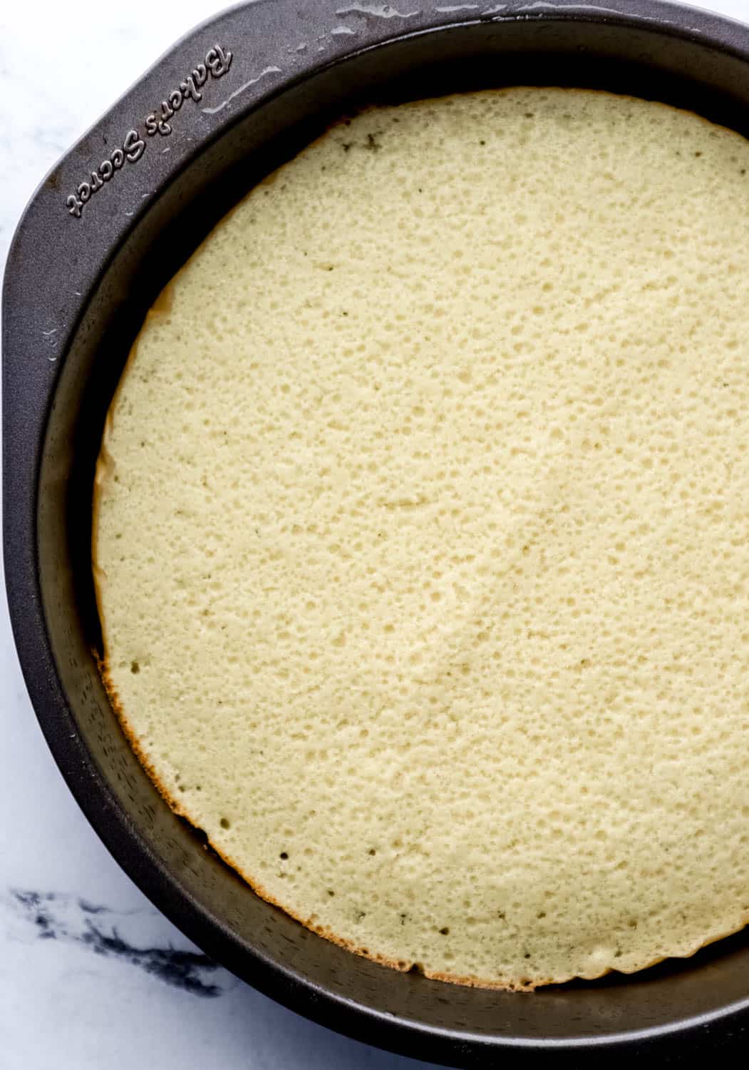 Bake cake in round parchment lined baking pan. 