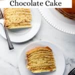 Overhead view of slices of cake on white plate with the rest of the cake in the background pin with text overlay.