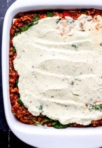 Layers of ingredients added to square baking dish.