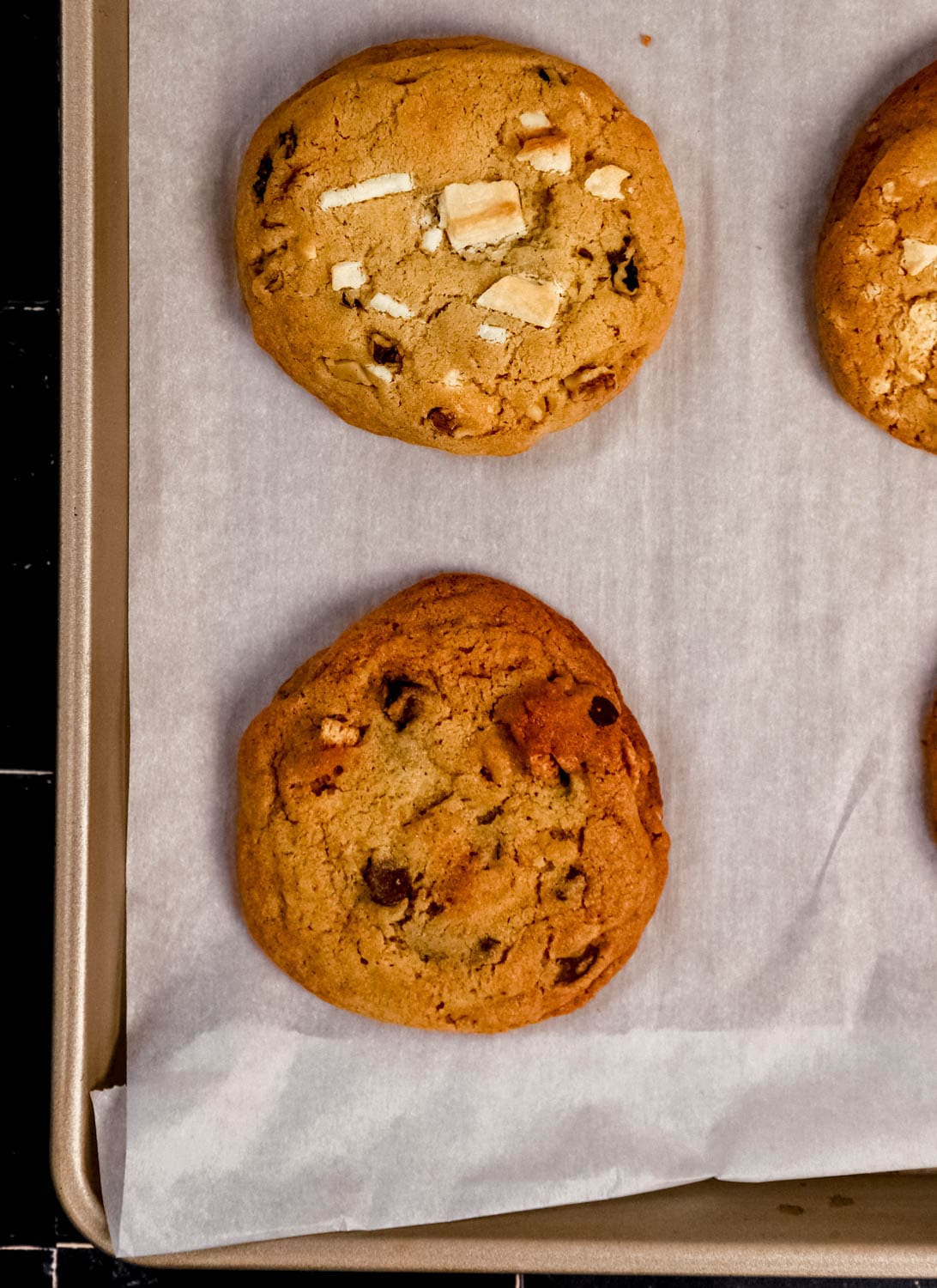 Overhead view of bakes cookies on parchment lined baking sheet. 