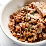 Close up front view of bowl of finished peas and pork in it.