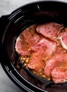 Peas and pork chops added to the crock pot.