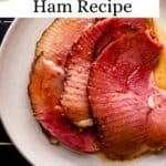 Overhead view of slices of glazed ham on white plate pin with text overlay.