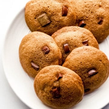 Overhead view of coffee cookies on white plate.