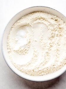 Overhead view of flour mixture to make cookies in a white bowl.
