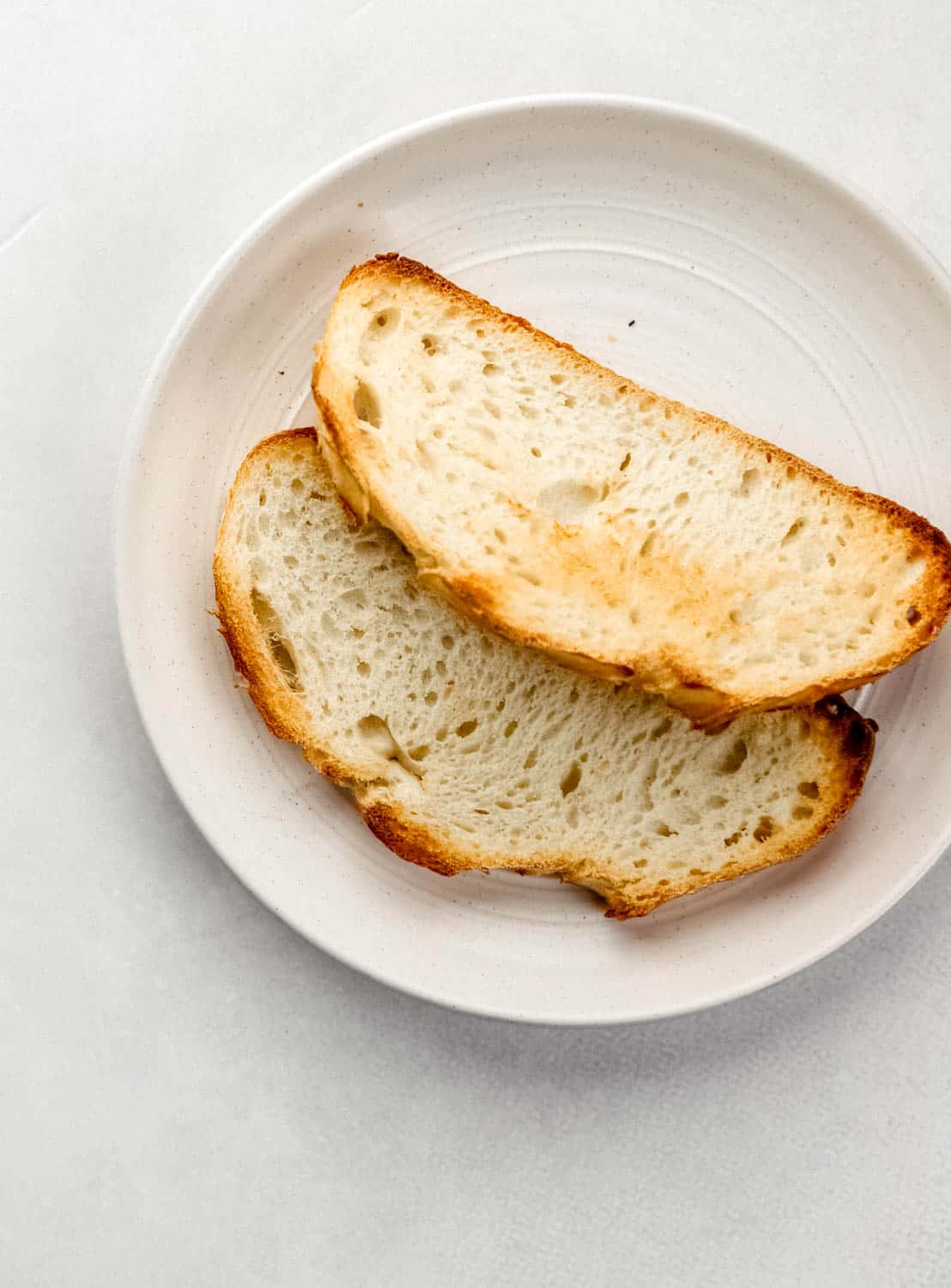 Overhead view of toast on white plate. 