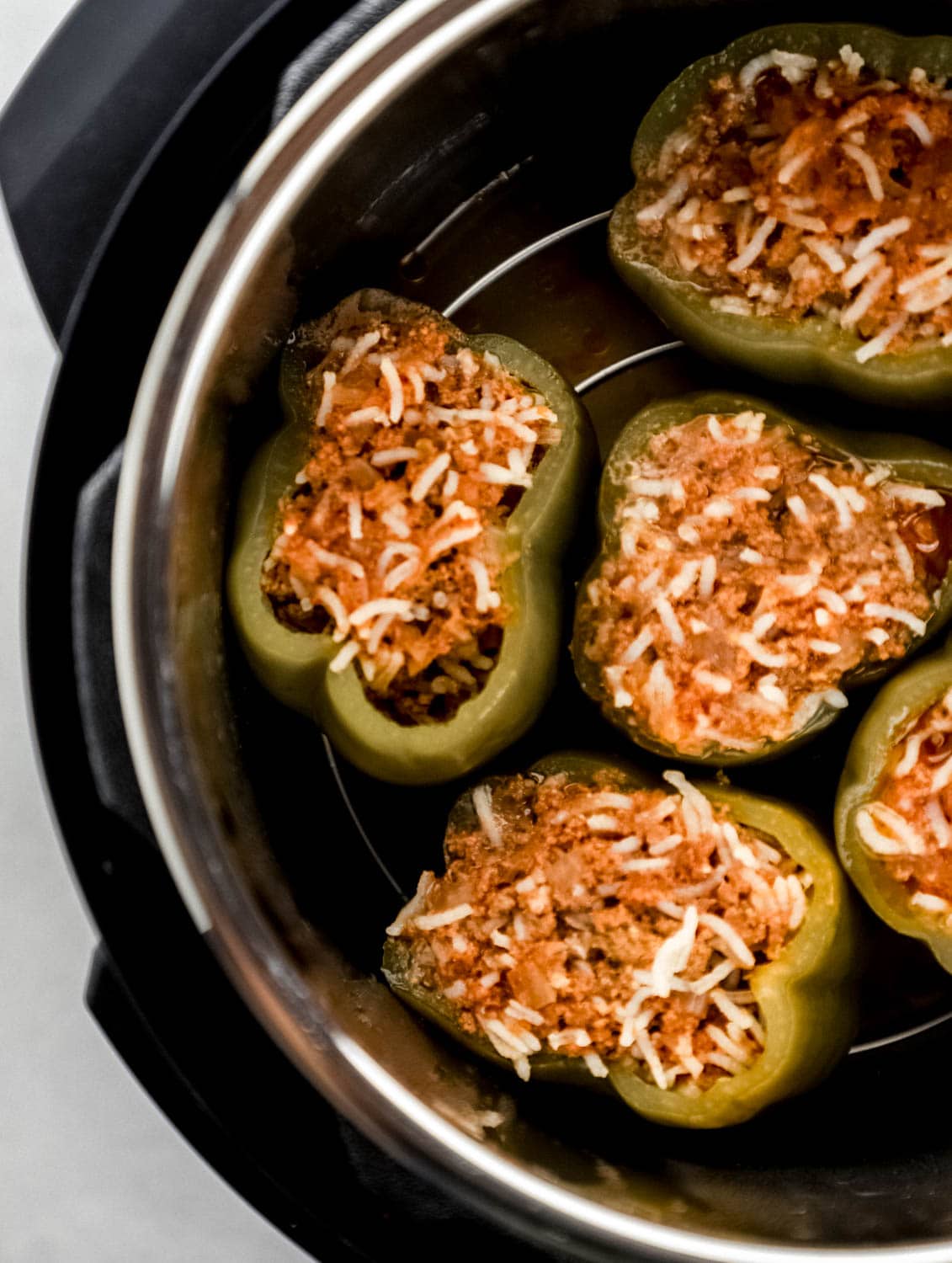 Overhead view of cooked stuffed pepper in instant pot. 