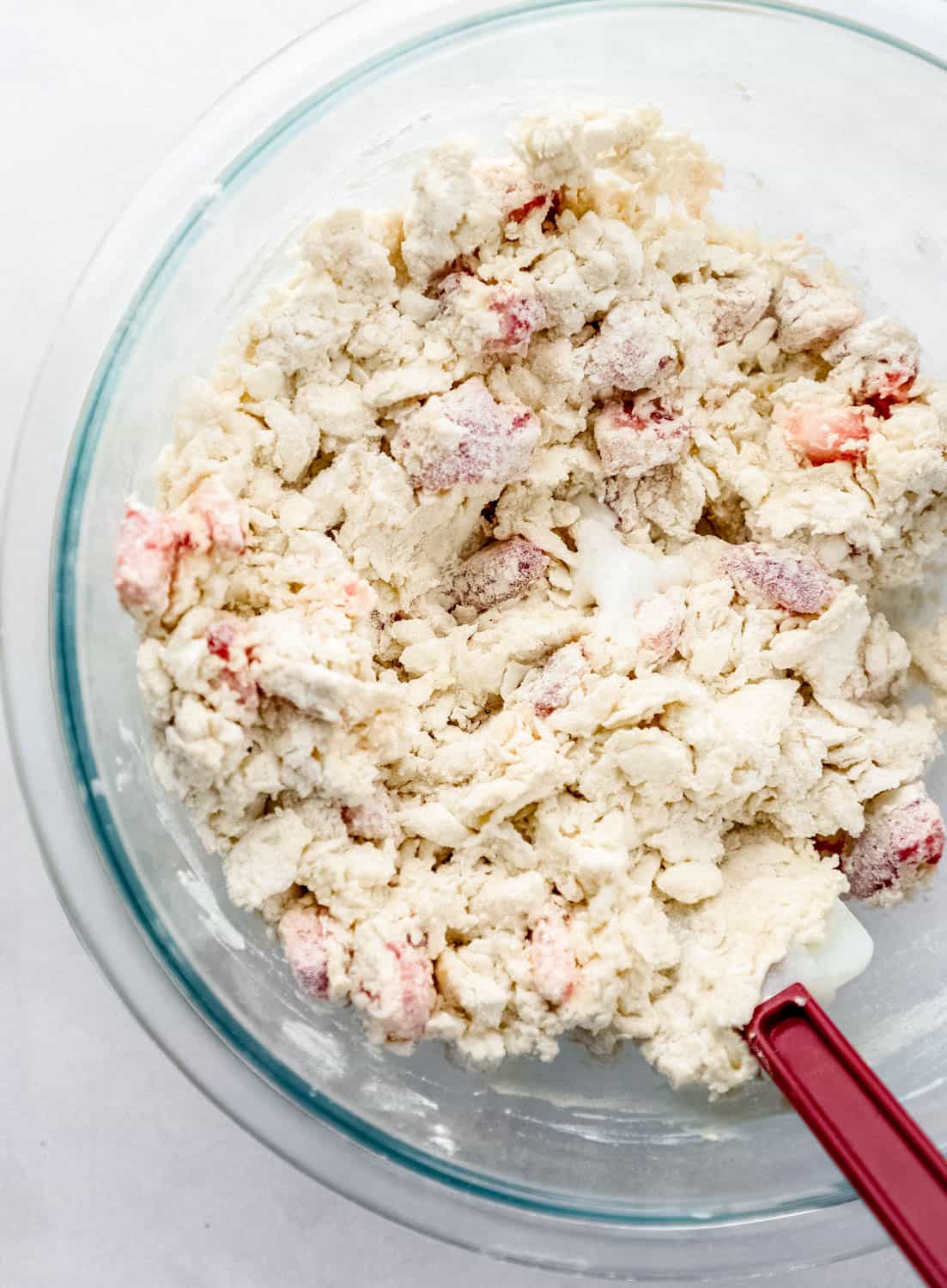 Biscuit dough in large glass mixing bowl. 