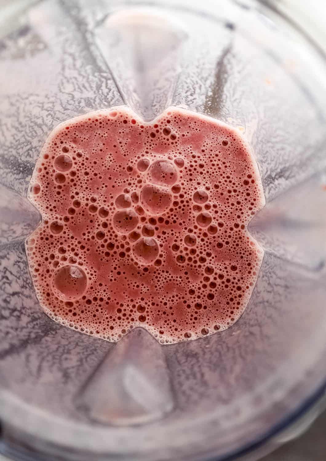 Close up overview shot of blender pitcher with smoothie in it. 