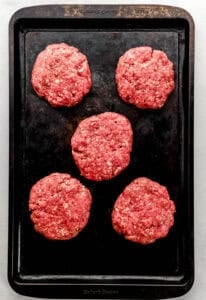 Hamburger patties on sheet pan.