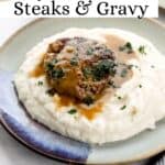 Front view of steak, gravy, and potatoes on plate pin with text overlay.
