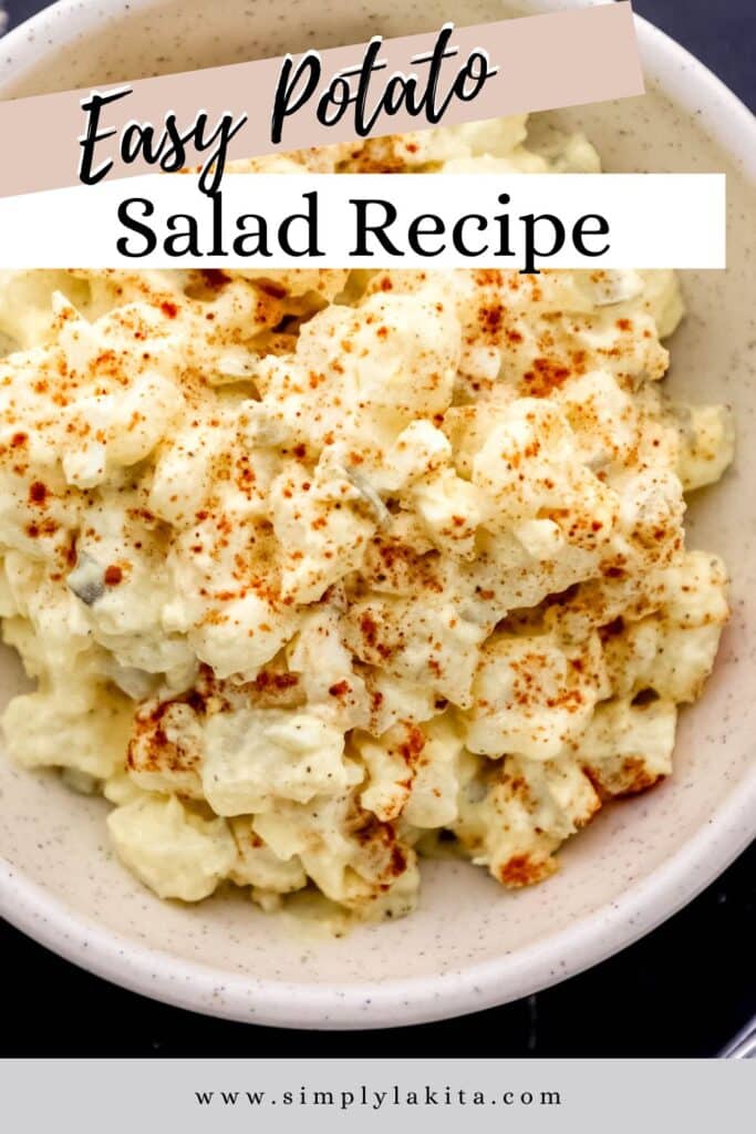Overhead view of potato salad in white bowl topped with paprika pin with text overlay.