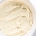 Overhead view of mashed potatoes in large white mixing bowl.