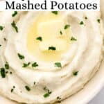 Overhead view of bowl of mashed potatoes on pin with text overlay.