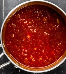 BBQ sauce ingredients combined in saucepan.