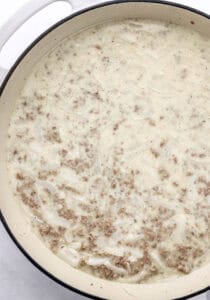 Overhead view of all gravy ingredients combined in skillet.