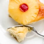 Single slice of cake on white fork with fork in it.
