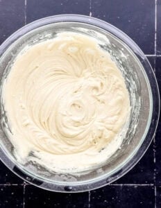 Cake ingredients combined in glass mixing bowl.