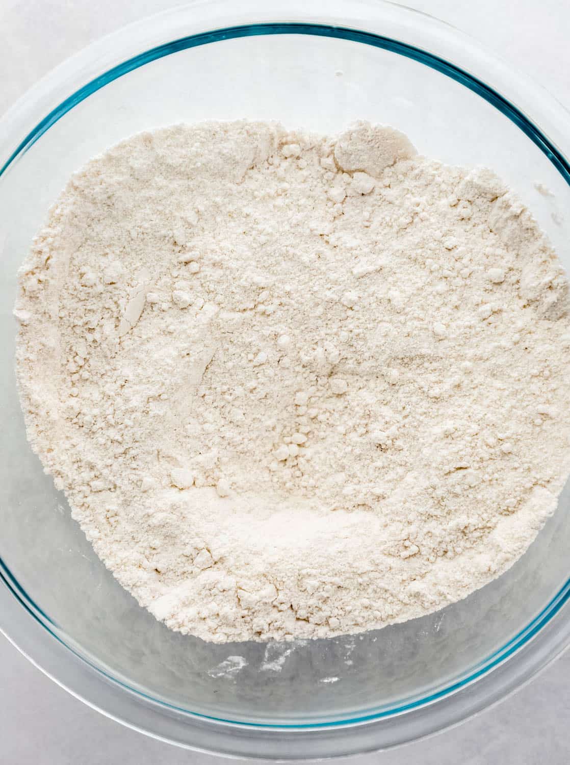 Dry cake ingredients added to a large glass mixing bowl.
