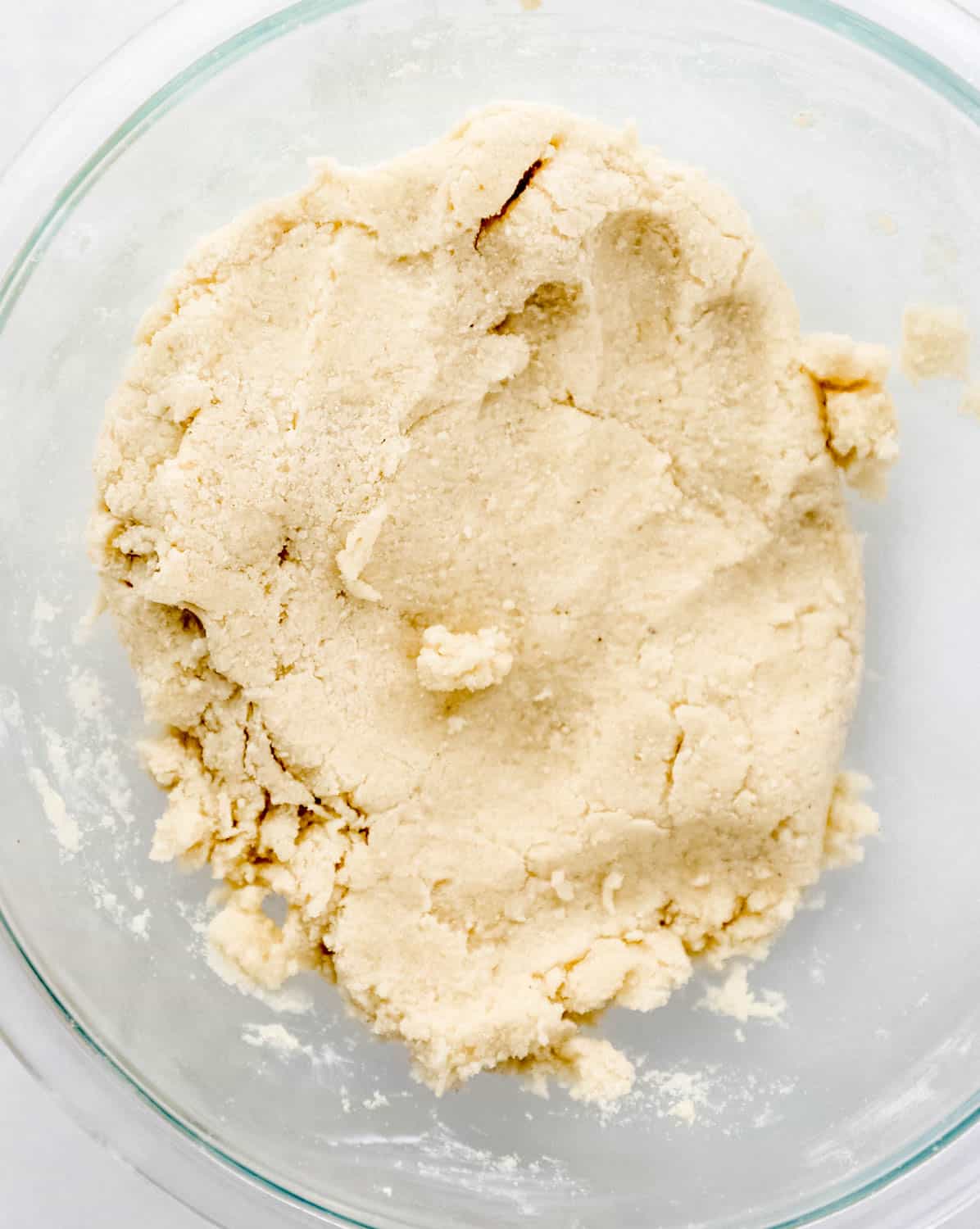 Overhead view of shortcake soft dough in large glass mixing bowl.