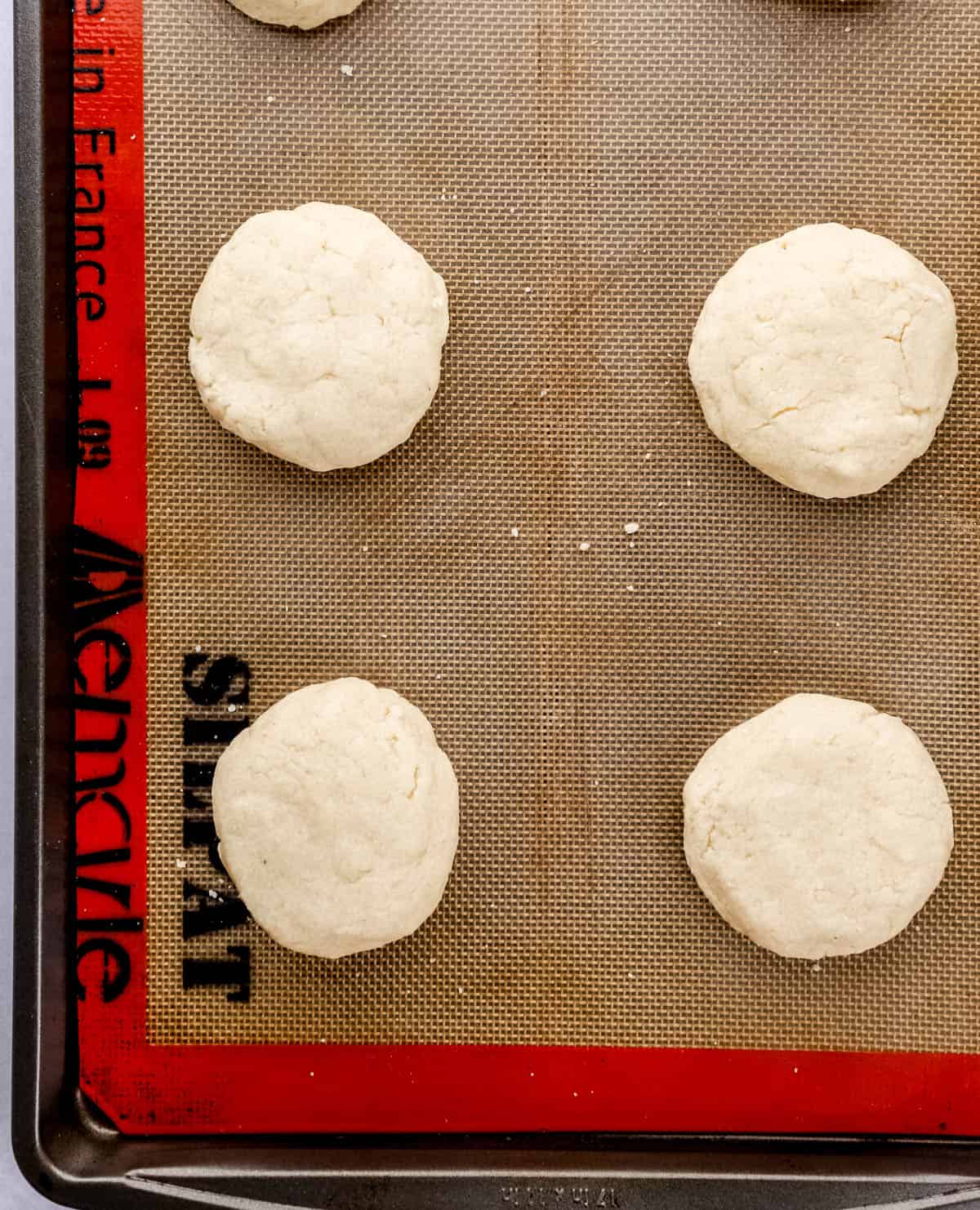 Shortcake dough added to large baking sheet lined with nonstick mat.