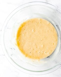 Muffin ingredients combined in large glass mixing bowl.