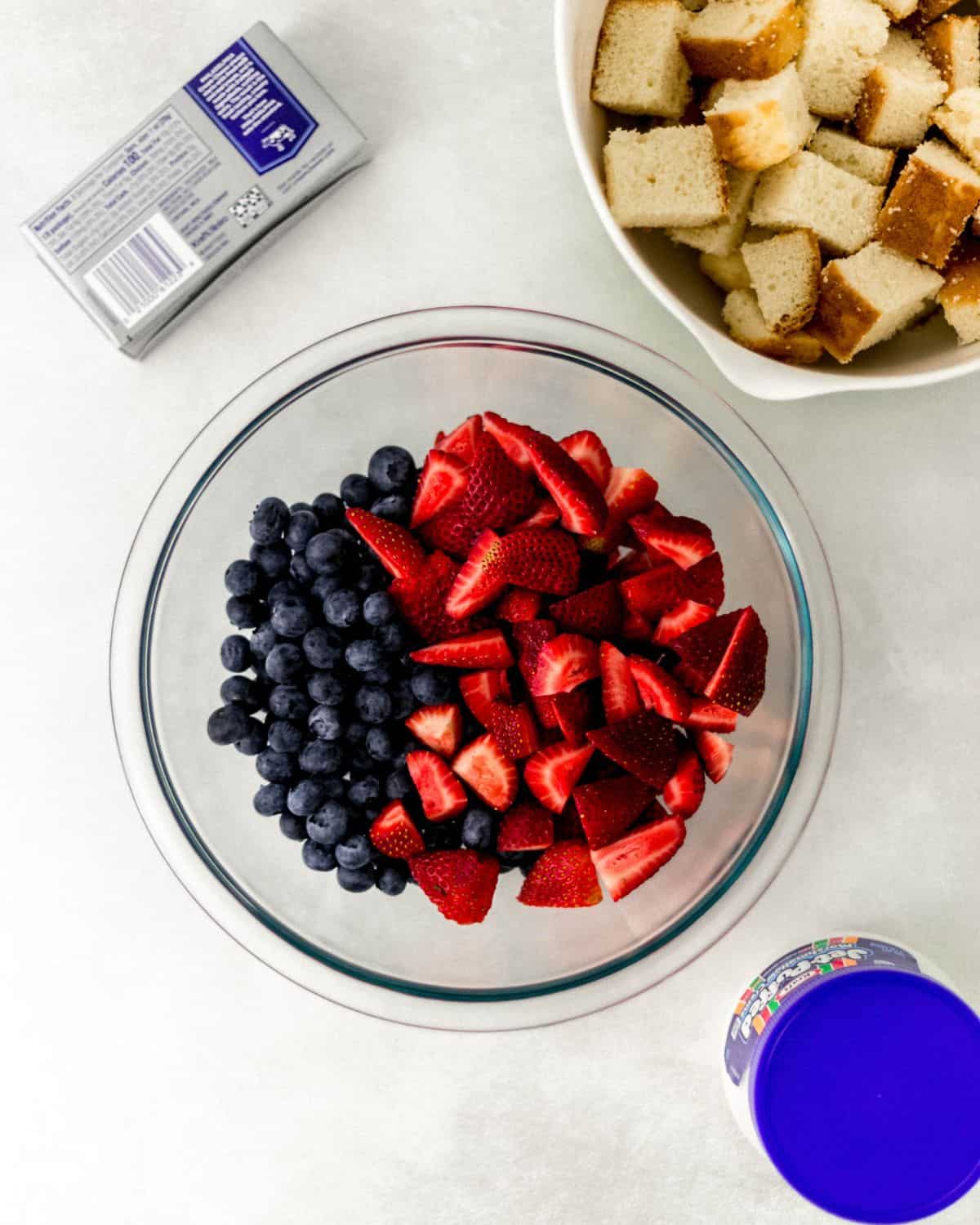 Overhead view of ingredients needed to make trifle in separate containers. 