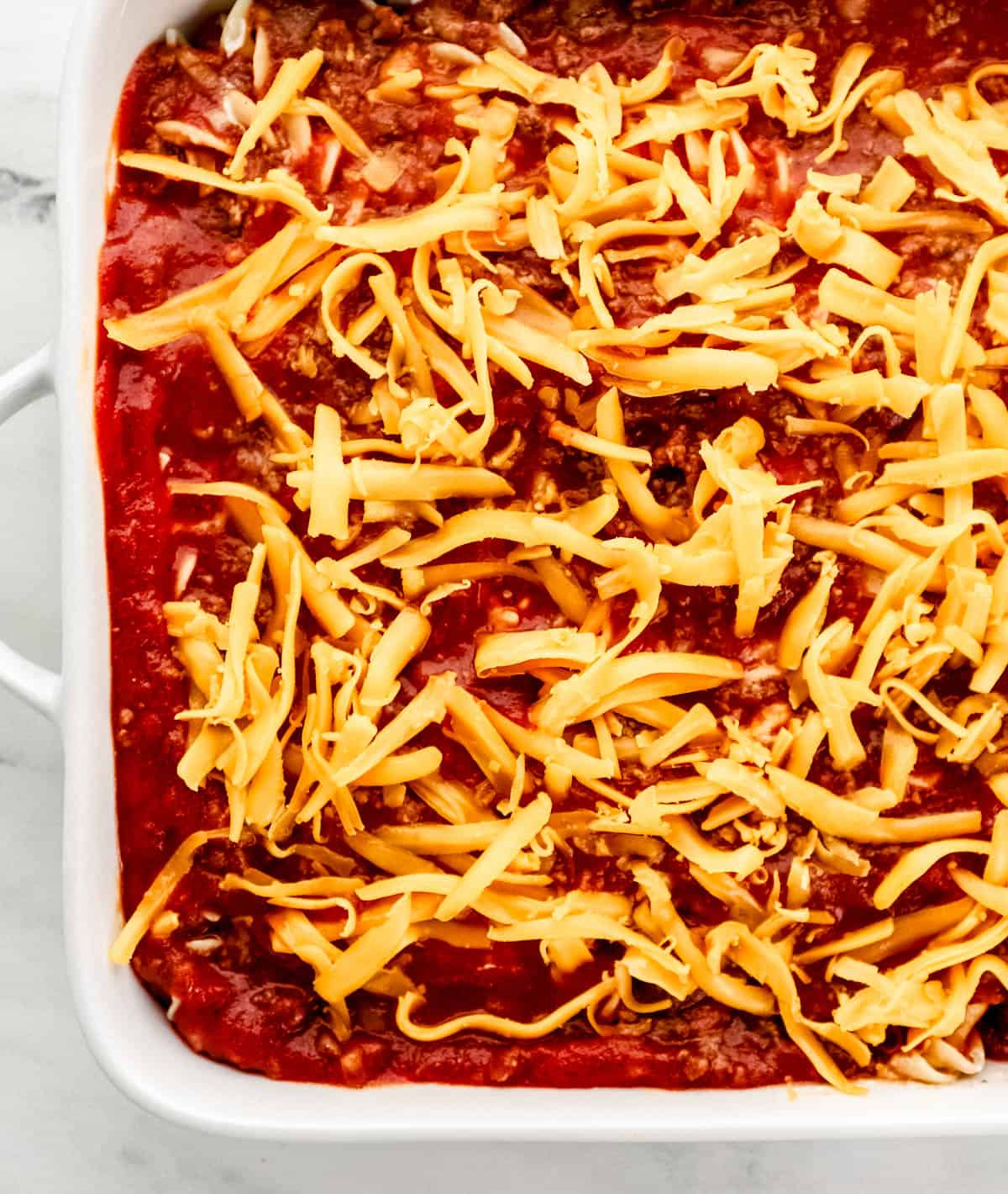 Shredded cheese added to the top of the casserole before baking. 