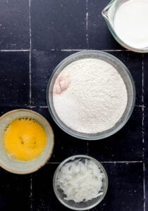 Ingredients needed to make hush puppies in separate bowls.