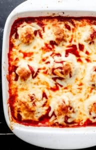 Close up overhead view of baked casserole in white baking dish.