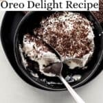 Single serving of oreo delight in black bowl with spoon in it on plate with cookies pin with text overlay.
