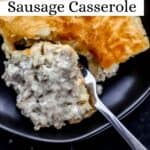 Close up overhead view of single piece of casserole on black plate with a fork cutting into it.
