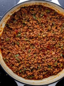 Sloppy joe sauce added to the other beef mixture ingredients in the braiser.