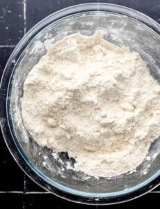 Cobbler crust ingredients combined in glass mixing bowl.