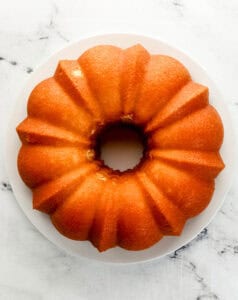 Overhead view of cake removed from pan and added to plate.