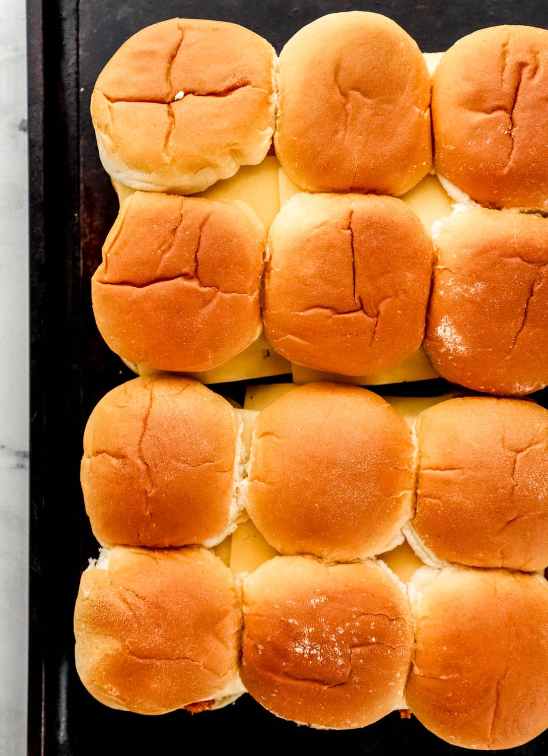 Overhead view of assembled sliders on baking sheet.
