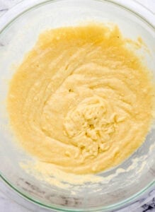 Cornbread mix in large glass mixing bowl.