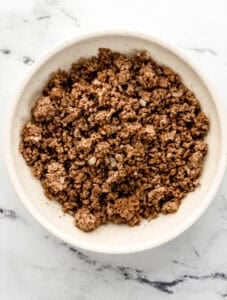 Overhead view of bowl of cooked ground beef.