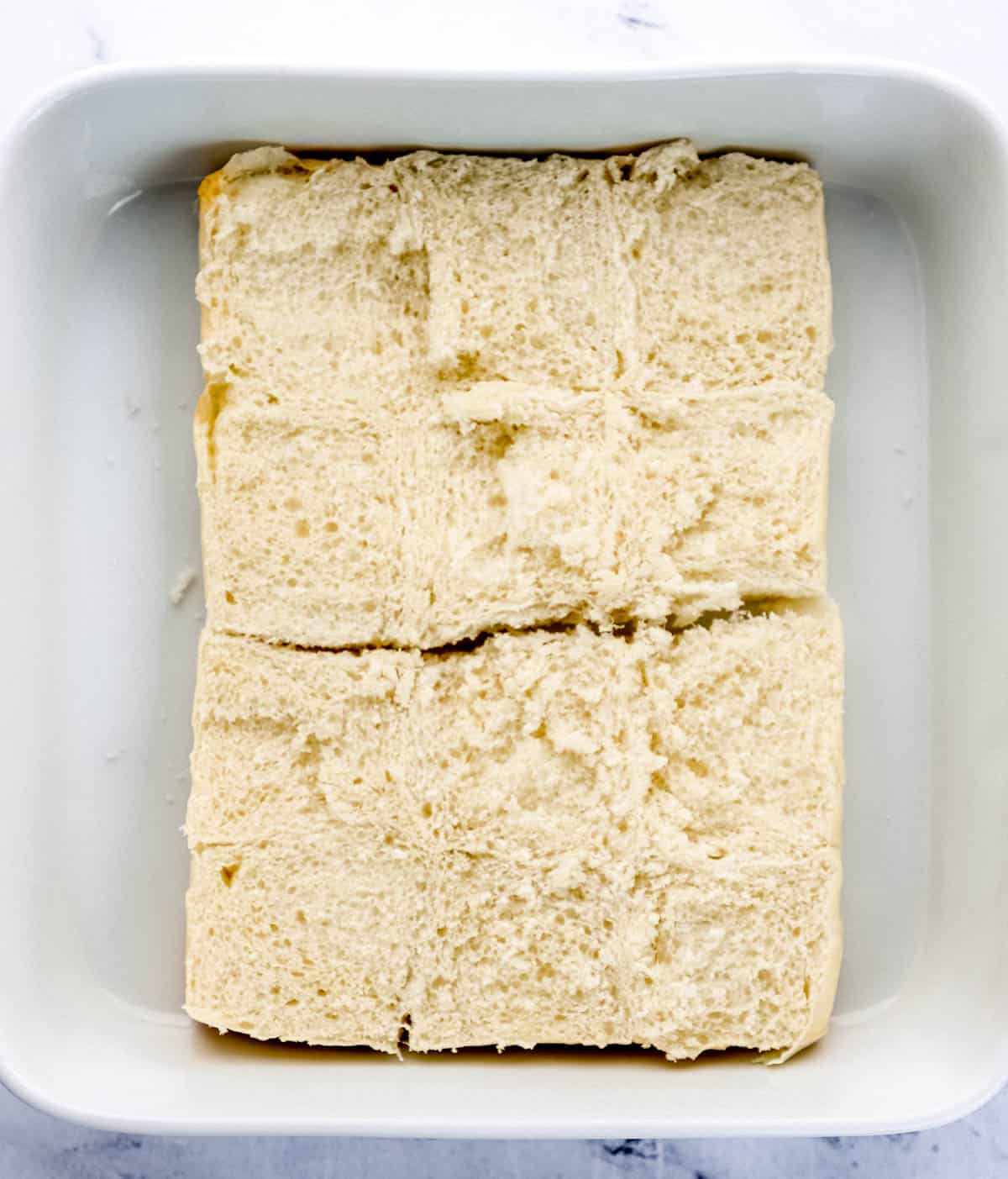 Bottom half of slider buns added to the bottom of a baking dish. 
