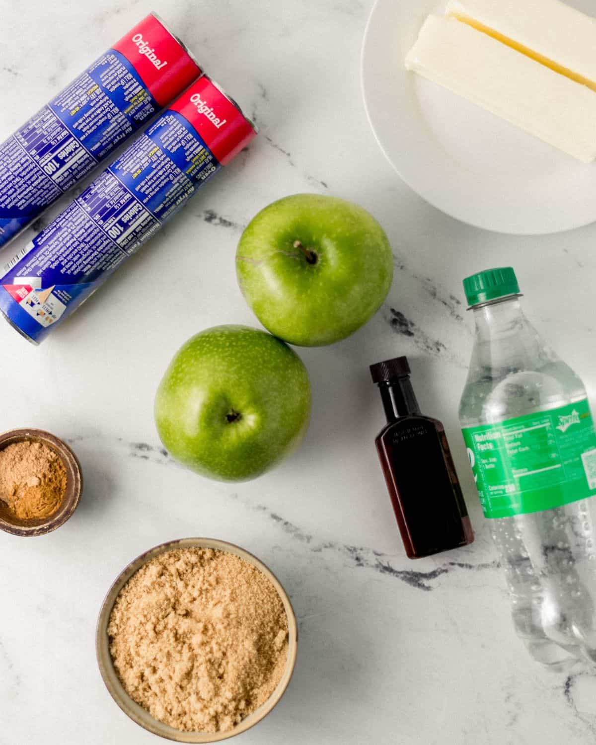 Overhead view of ingredients needed to make dumplings on marble surface. 