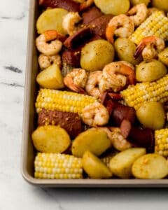 Close up front view of shrimp boil in sheet pan.