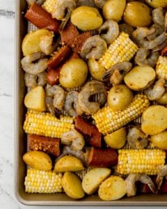 Shrimp boil on sheet pan before cooking.