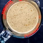 Overhead view of sauce ingredient blended in glass measuring cup.
