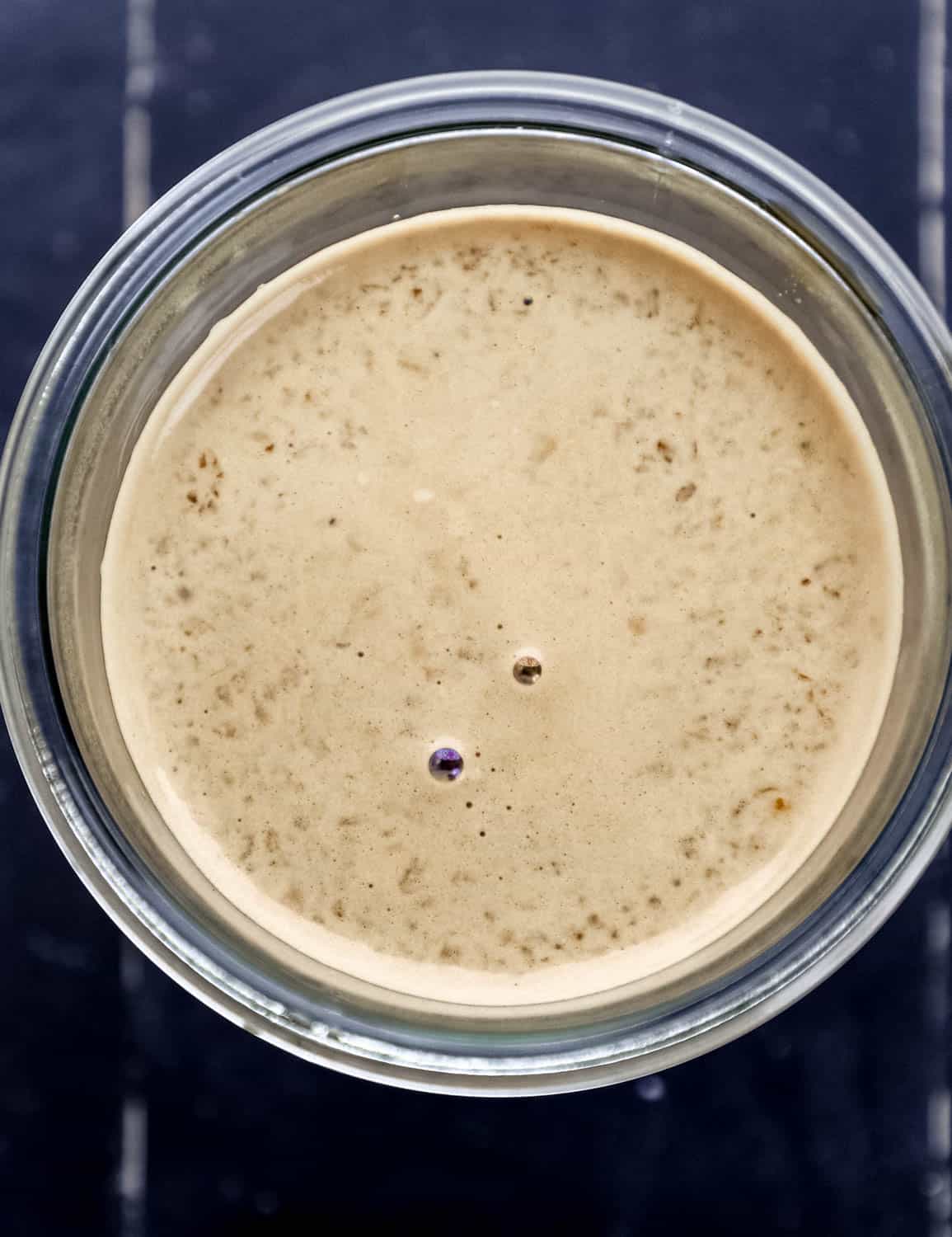 Close up overhead view of finished sauce in glass jar. 
