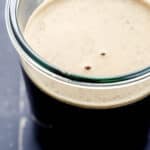 Close up side view of finished sauce in glass jar.