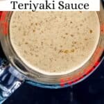 Overhead view of sauce ingredients blended in glass measuring cup on pin with text overlay.