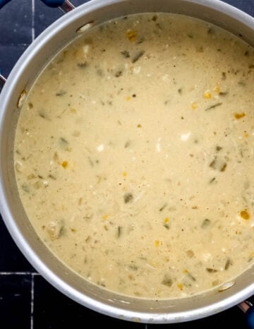 Overhead view of cream cheese and heavy cream added to the pot with the other ingredients.