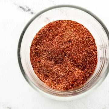 Close up overhead view of homemade chili seasoning in glass bowl.